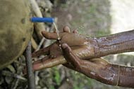 Muche Semachu washes his hands, another way to keep clean and prevent trachoma, which is spread by human contact and flies.