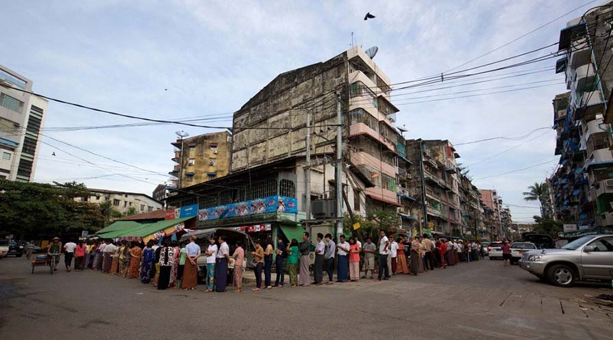 Photo of voters waiting in a long line.