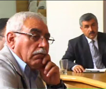 Photo of non-governmental Palestinian representatives watching President Carter's press conference.