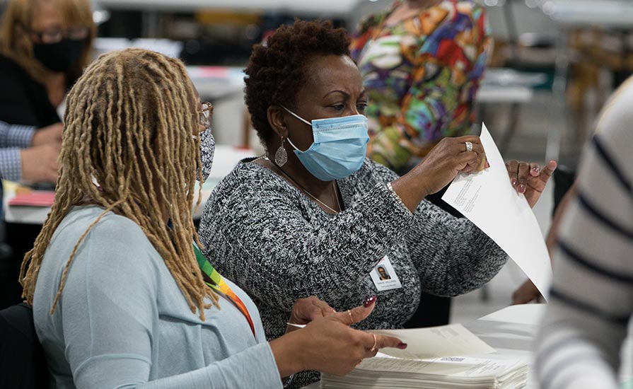  In Gwinnett County, Georgia, two workers count ballots by hand in an audit of the presidential election. The Carter Center sent observers to 24 counties in the state, representing 60% of the votes cast. (Photo: The Carter Center/R. Borden)