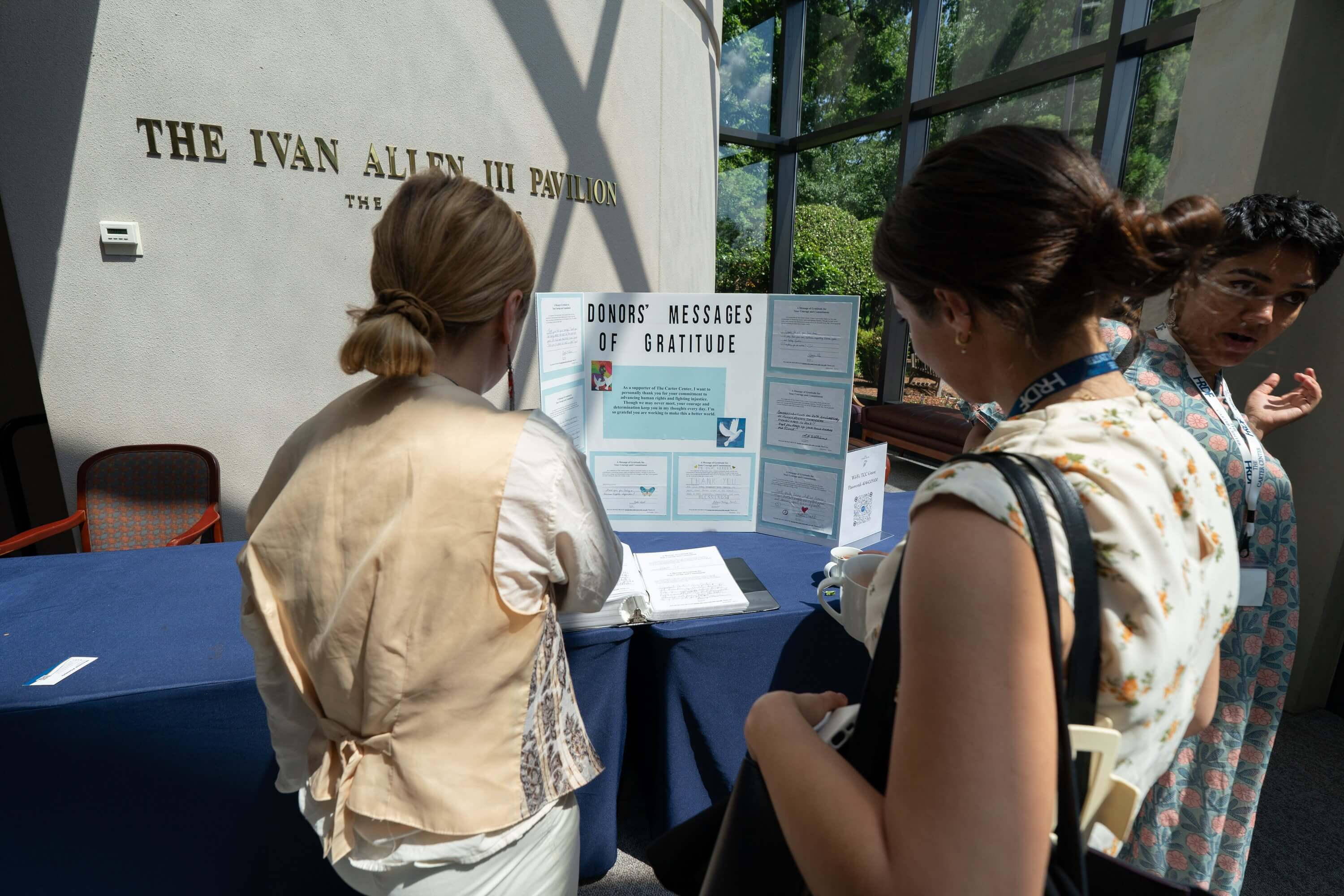 Two women look at a poster. 