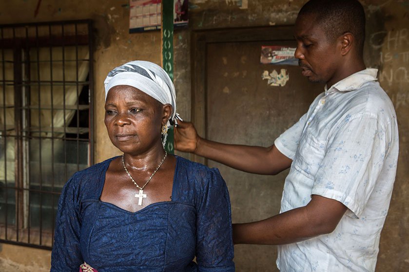 Community-directed drug distributor Gabriel Ani measures Cordelia Anude of Nigeria’s Enugu state to determine her annual treatment for river blindness disease