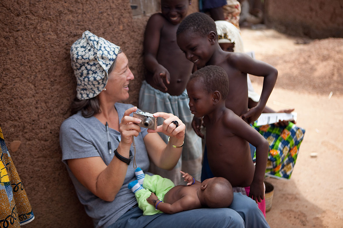 A 17-year Carter Center staff member, Callahan shares photos with a group of boys during a trip to Ghana. (Photo: The Carter Center/ N. Farese)