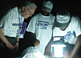 Preparing to count by lanternlight, former U.S. President Jimmy Carter observes poll closing procedures in Monrovia during Liberia's 2005 national elections.