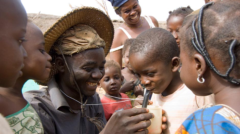 Photo of a child drinking from a pipe filter.