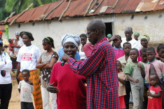 A Liberian woman asks a question following a drama troupe's presentation on Liberian laws.