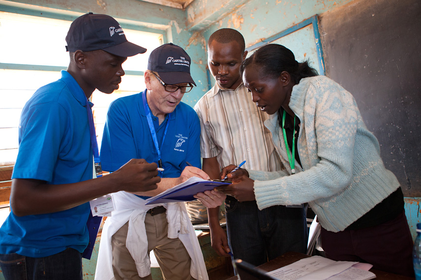 Carter Center observers Emile Codjo and Thomas Koenig confer with polling station officials at Mukarara Primary School in Nairobi. Carter Center short-term observers witness voting and counting in the days surrounding election day, but the Center's long-term observers have observed the electoral process since January.