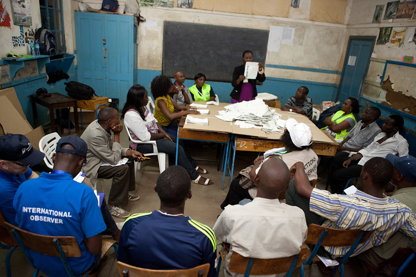 Presiding Officer Lillian Anyango displays a marked ballot during the vote counting process in the view of party agents and election observers at Kilimani Primary School polling station in Nairobi.